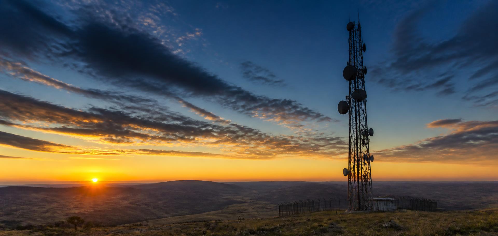 A telecommunications tower silhouetted against a Mpumalanga sunset